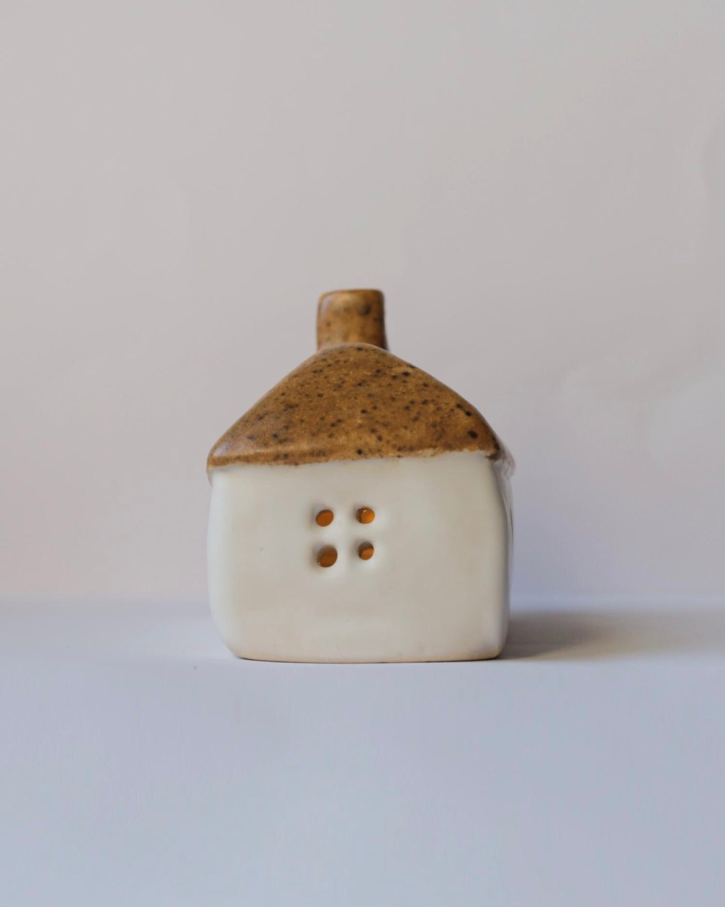 Ceramic house with brown roof