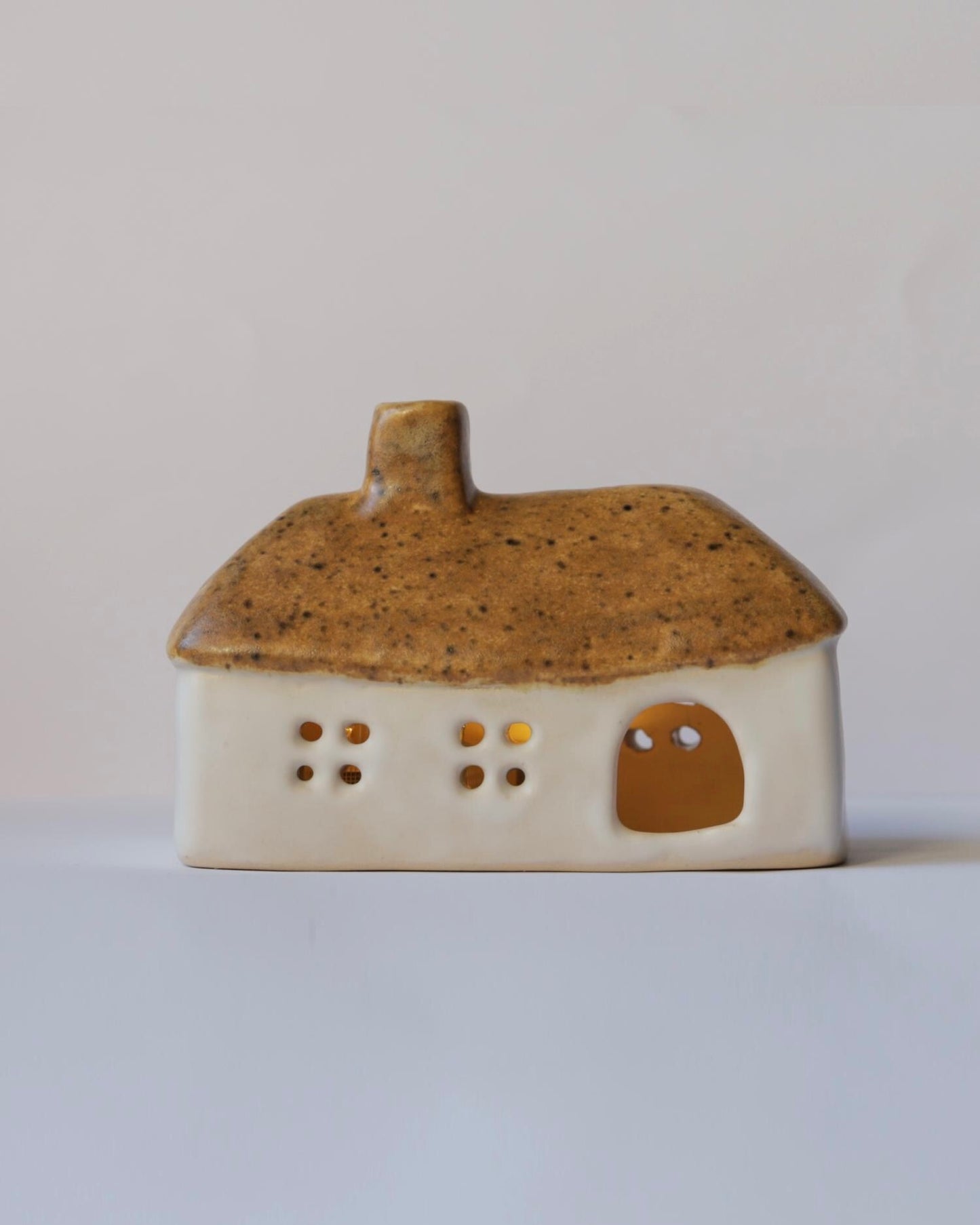 Ceramic house with brown roof