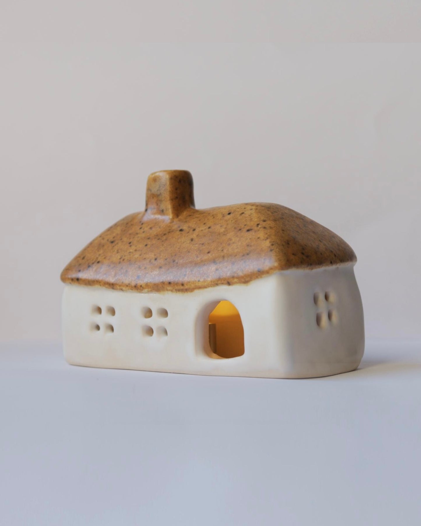 Ceramic house with brown roof