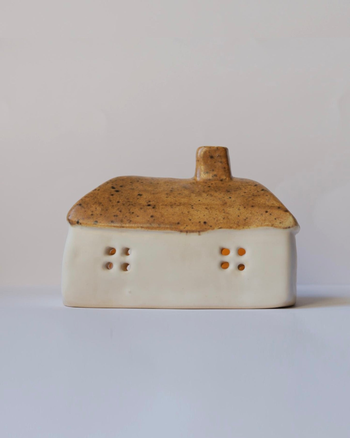 Ceramic house with brown roof
