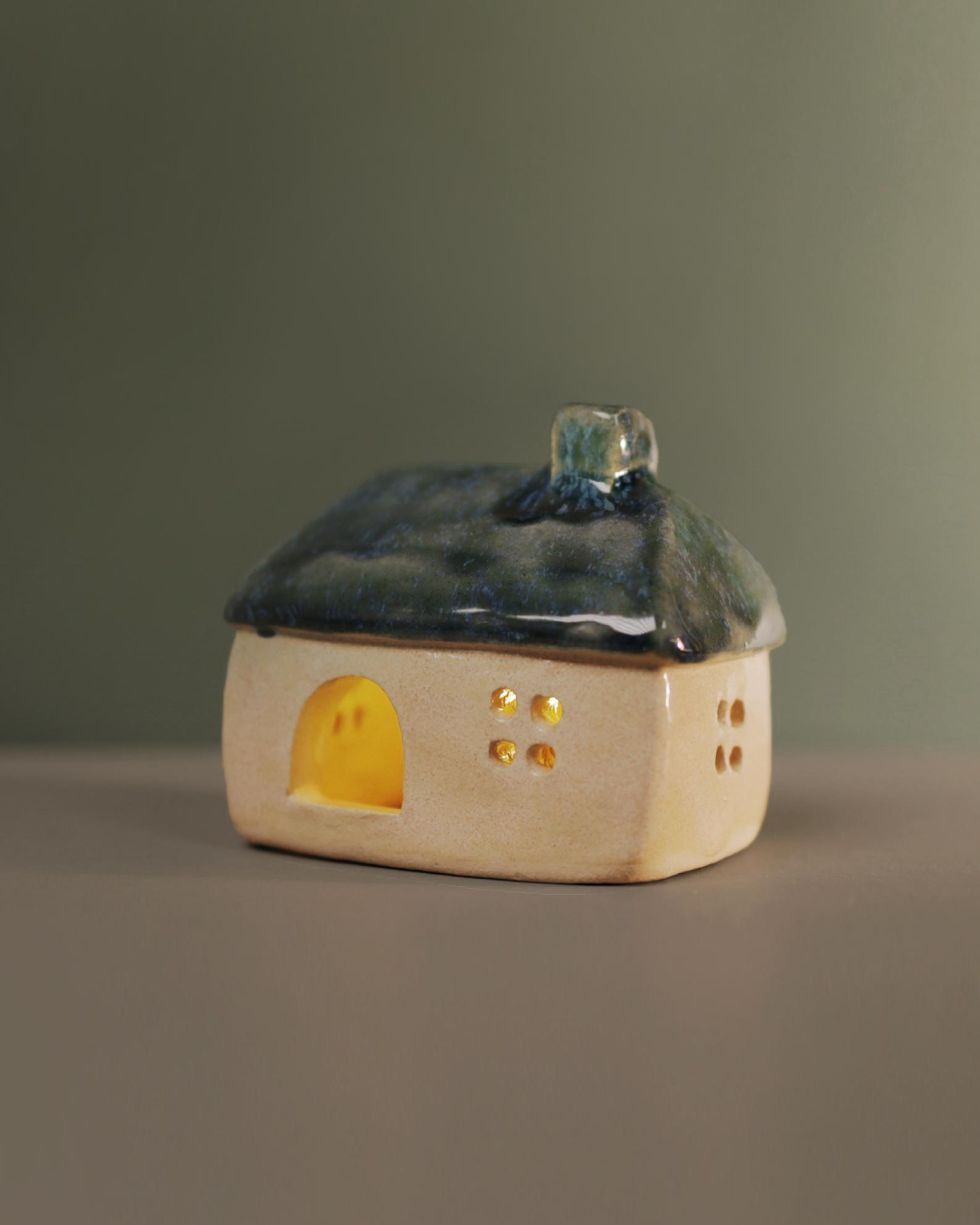 Ceramic house with blue-green roof