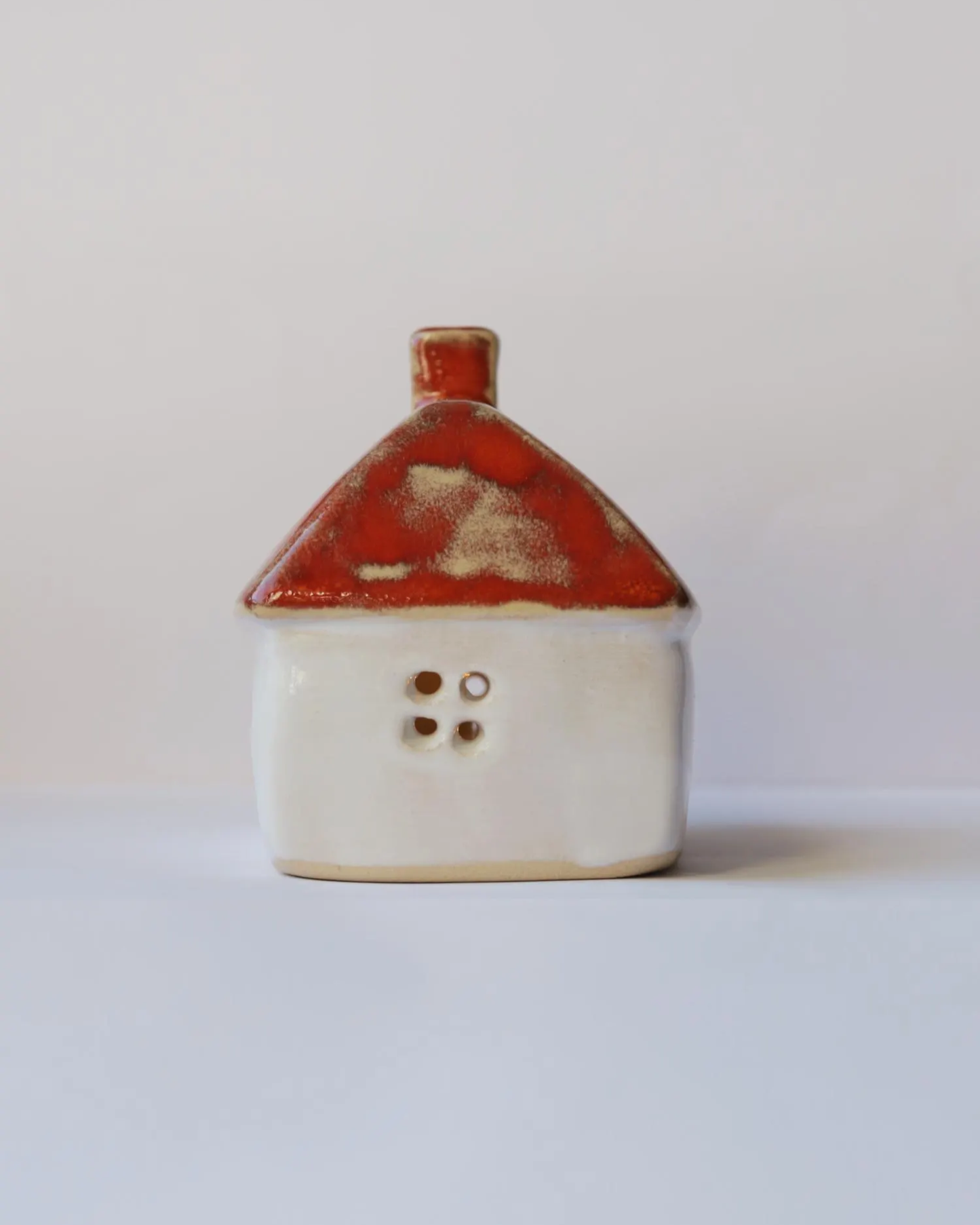 Ceramic house with orange roof