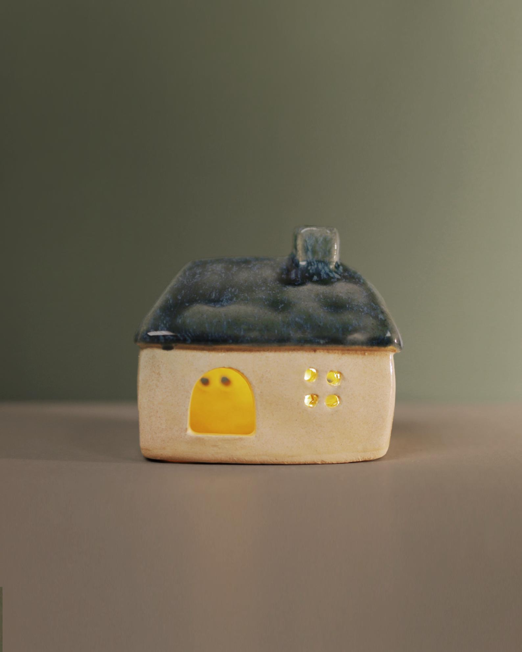 Ceramic house with blue-green roof