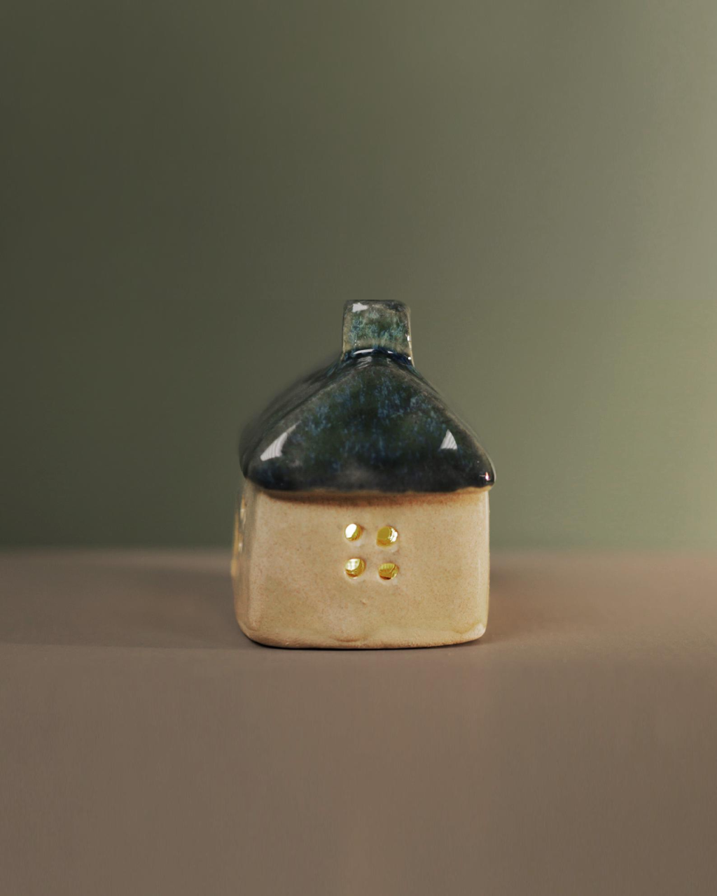 Ceramic house with blue-green roof