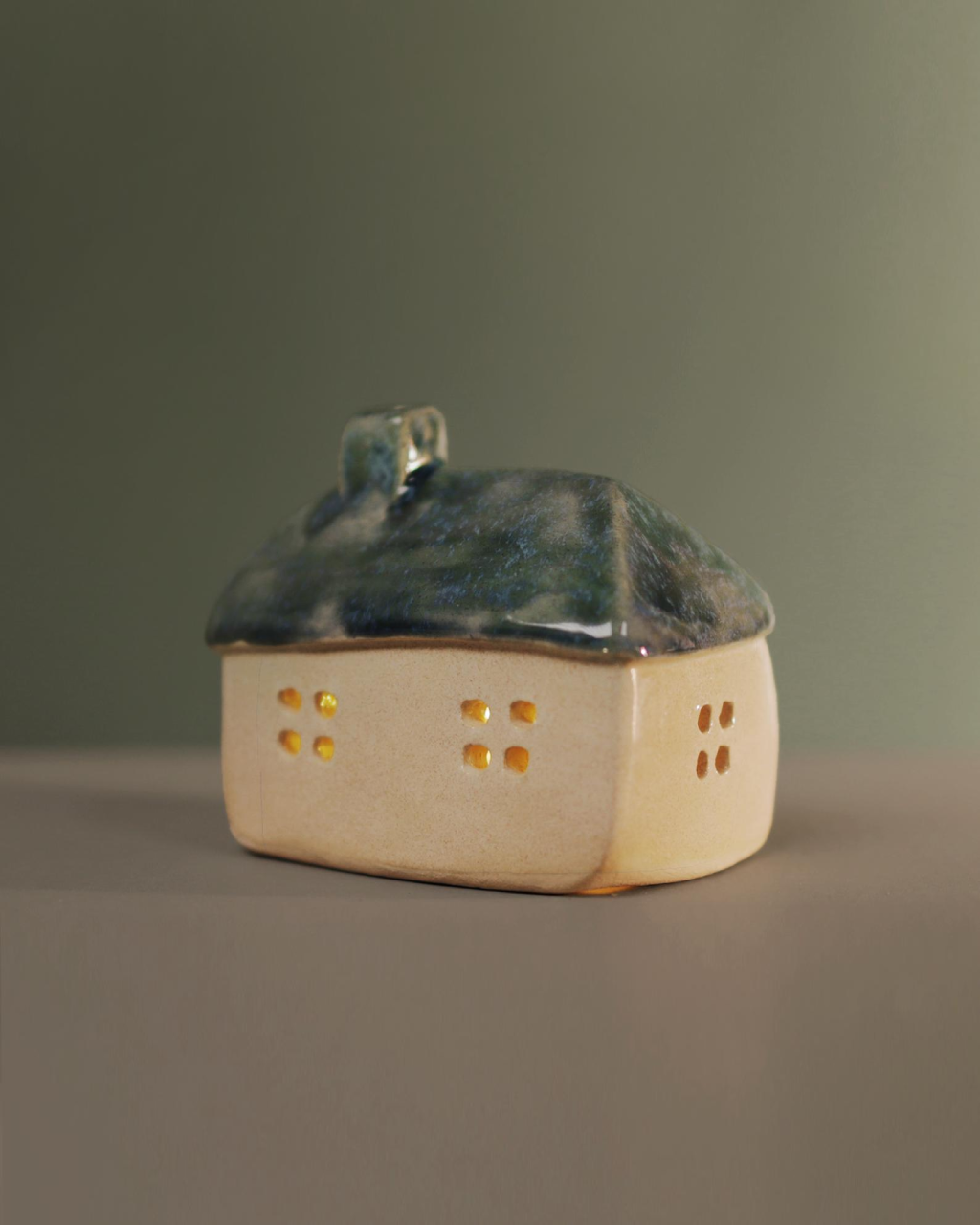 Ceramic house with blue-green roof